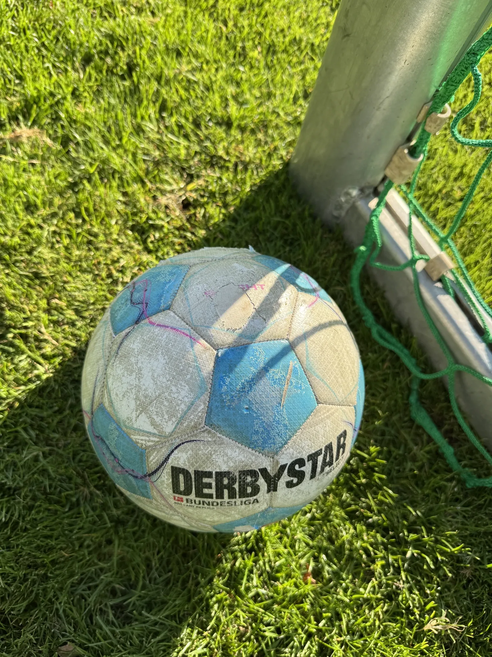 Blau-weißer Fußball vor einem Jugendtor